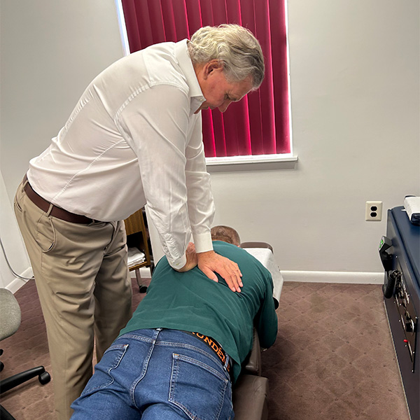 Dr. Schmetterling adjusting a patients back