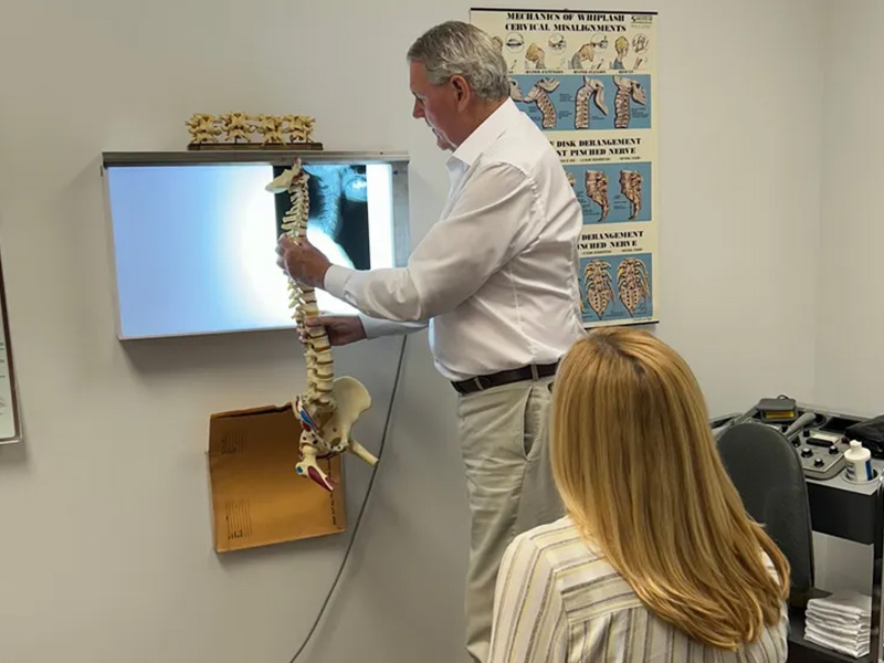 Dr. Schmetterling showing X-ray to patient